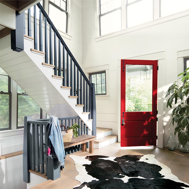 Entry hall with a front door in Benjamin Moore's 2018 color of the year, a deep red, and white shiplap walls