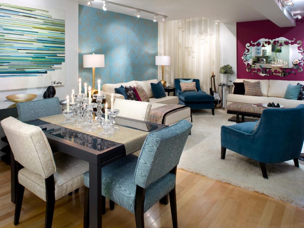 Living and dining room with a teal accent wall, blue armchairs, a cream sofa and a magenta wall at the back
