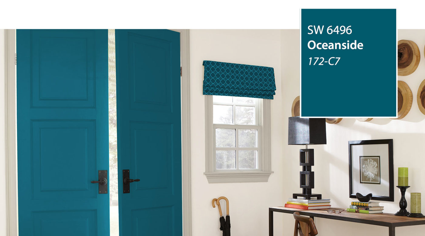 Double entry doors painted Sherwin-Williams Oceanside SW 6496, the 2018 color of the year, beside a console table