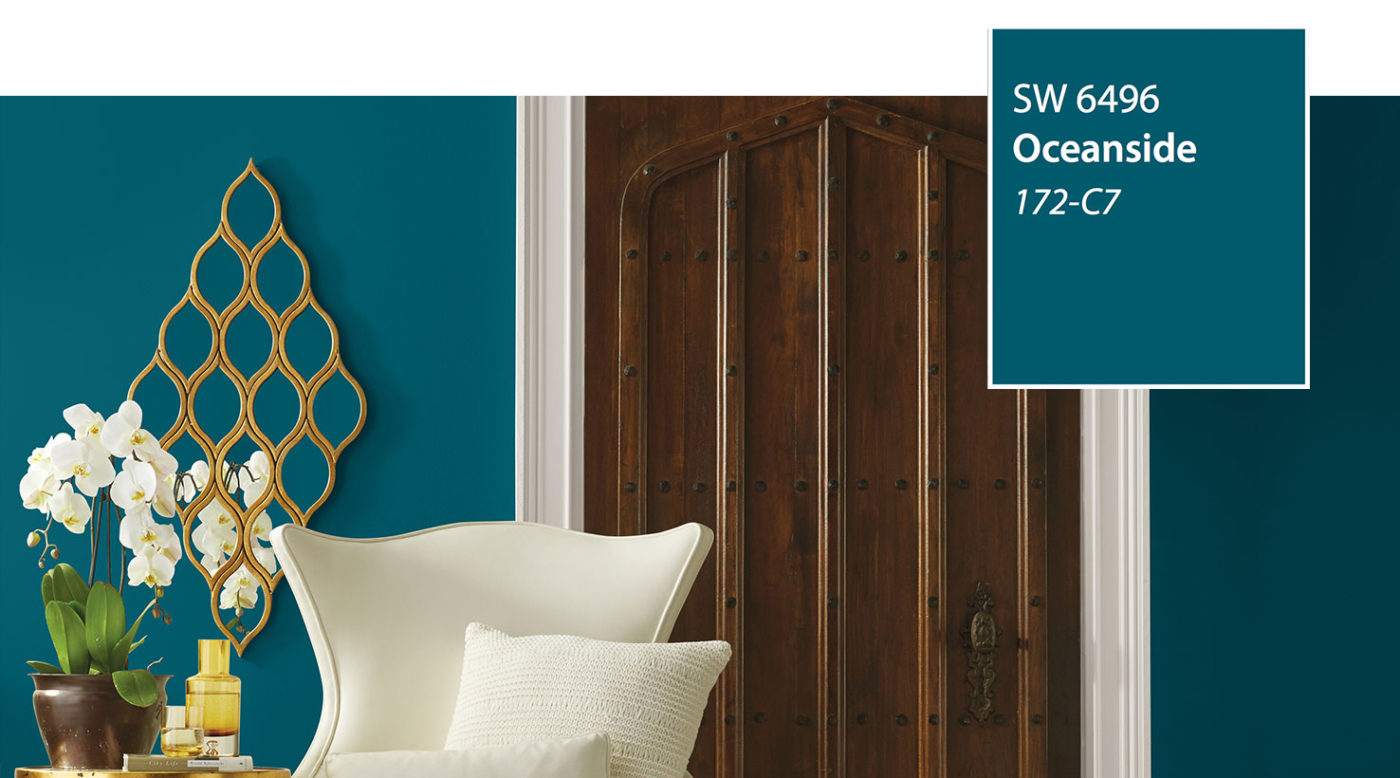 Teal wall in Sherwin-Williams Oceanside SW 6496 with gold wall art, a white wingback chair and white orchids